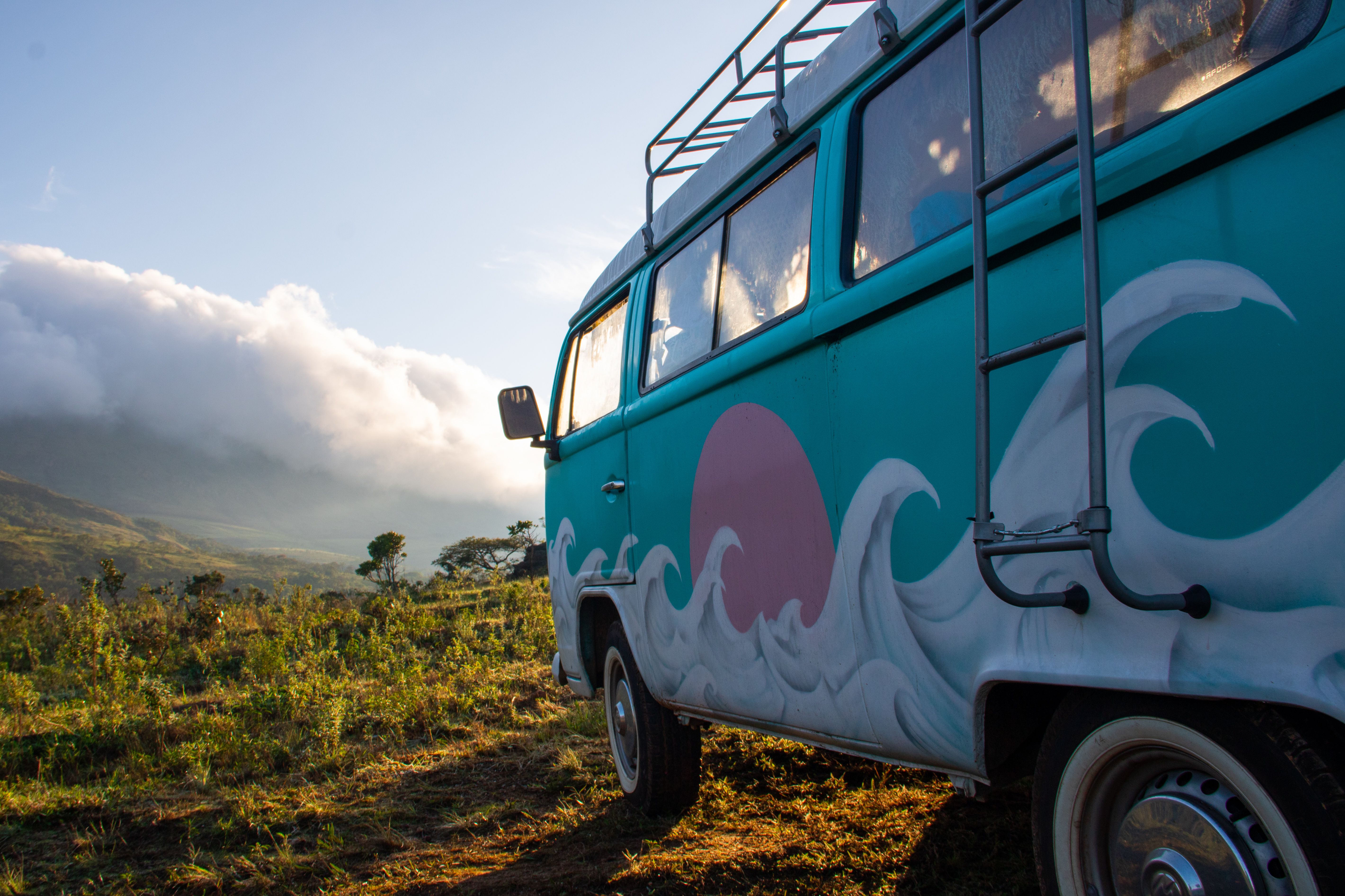 A campervan parked off-grid in the mountains at sunrise