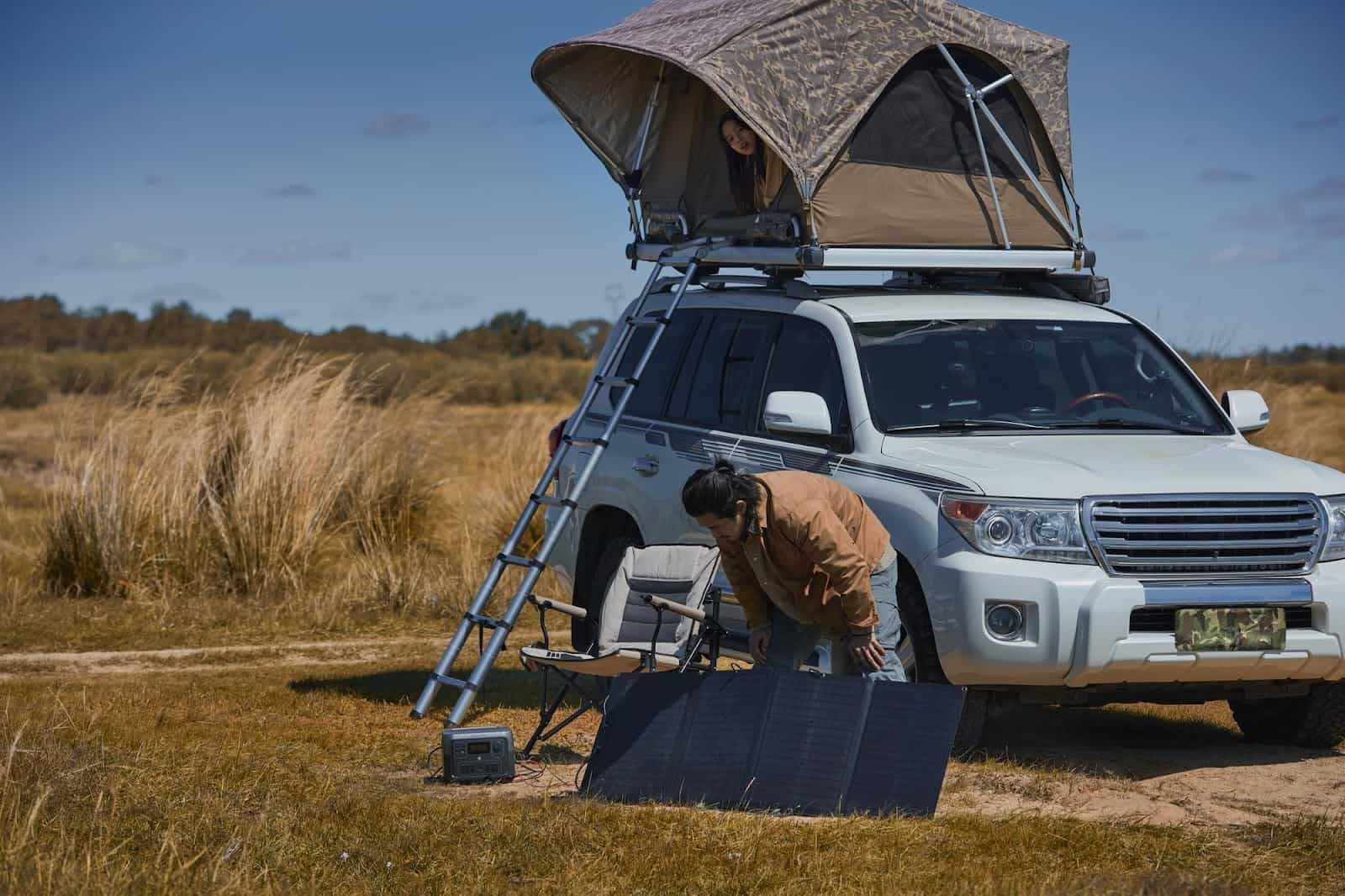Portable solar panel set up at a rooftop tent campsite