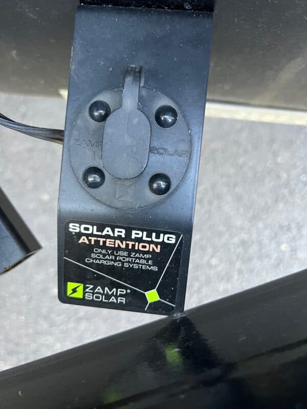 Close-up of a Zamp Solar Ready SAE port mounted on an RV sidewall